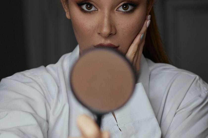 Close examination of skin with a dermatoscope